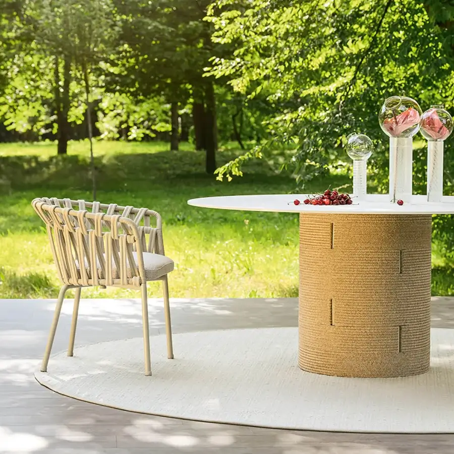 Elegant Varaschin Gianna table with cylindrical aluminum base and light-colored HPL tabletop in matte Desert finish