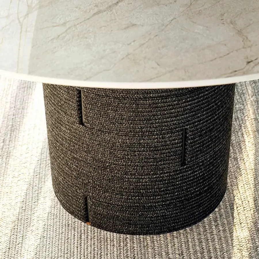 Distinguished Varaschin Gianna table with bush-hammered ceramic tabletop and dark, textured rope-like aluminum base crafted in Italy