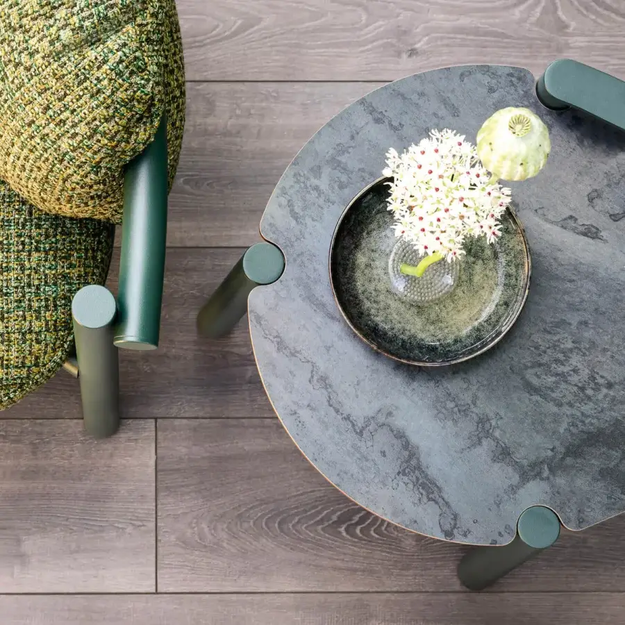 Distinguished Varaschin Allegra side table with dark green painted aluminum frame and textured stone-like composite tabletop
