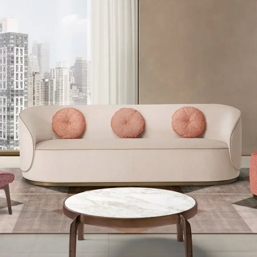 Distinguished CTS Salotti Fusion sofa upholstered in pale blush pink textile with quilted circular cushions and a smooth matte finish