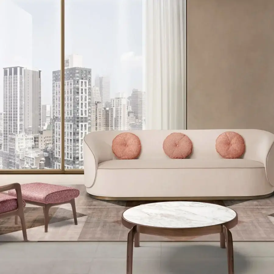 Lavish CTS Salotti Fusion sofa with a curved silhouette upholstered in pale beige textile and accented with rose-pink cushions plus a gold-toned base