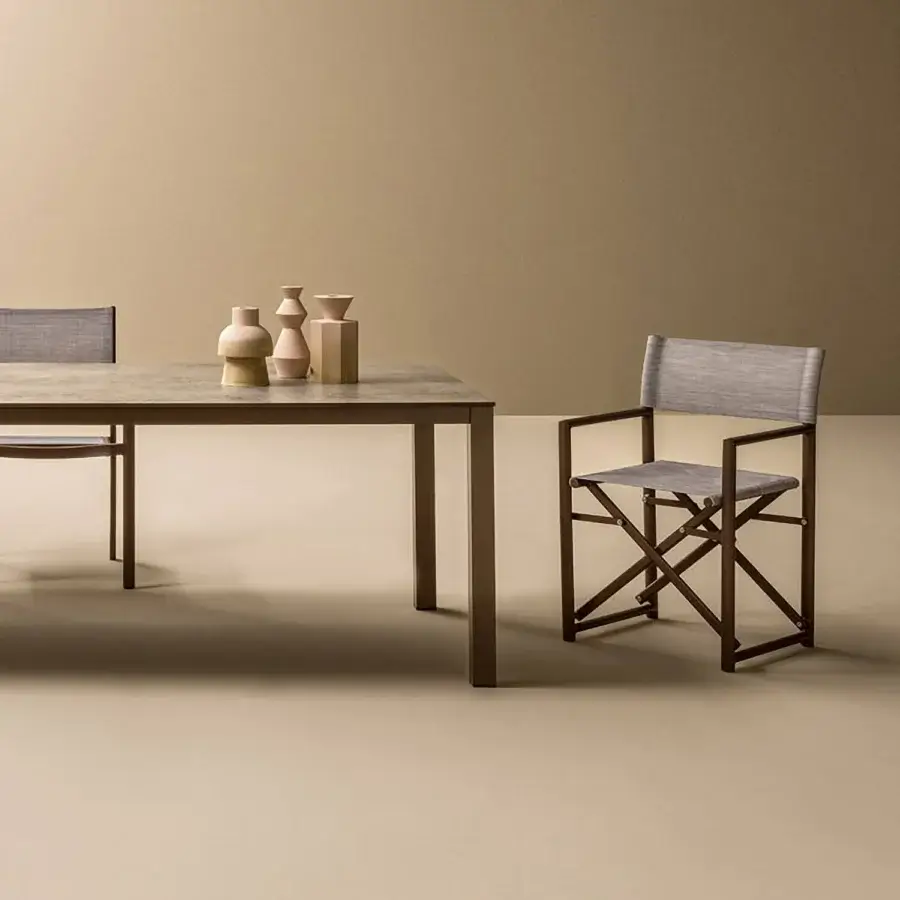 Elegant Varaschin Victor armchair with grey quilted fabric and matte bronze metal frame