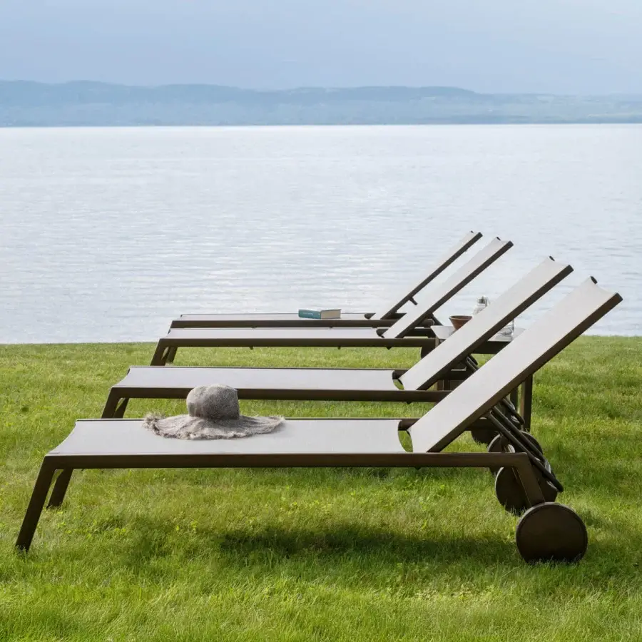 Distinguished Varaschin Victor lounger with aluminum build and earthy brown perforated Batyline fabric offering a textured finish