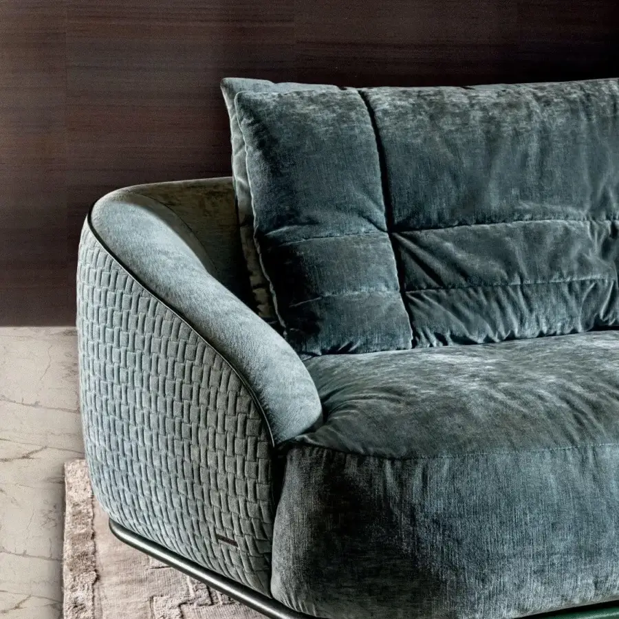 Lavish Visionnaire Holden sofa with plush grayish-blue velvet, quilted padding and a subtle metallic banded base