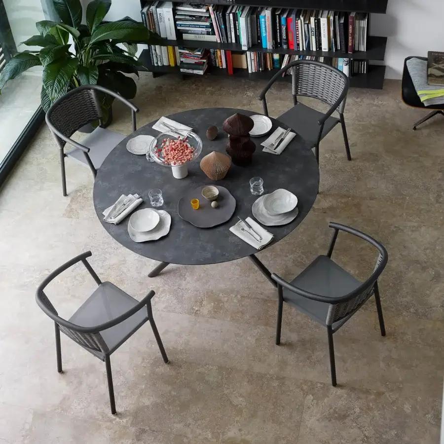 Exceptional Roberti Rattan Capri table with HPL top, powder-coated steel base and decorative searope detailing in a matte finish