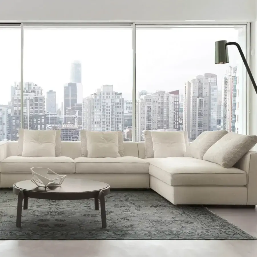 Lavish CTS Salotti Clay sectional upholstered in subtly textured neutral beige fabric with refined contrasting piping and elegantly stitched cushions