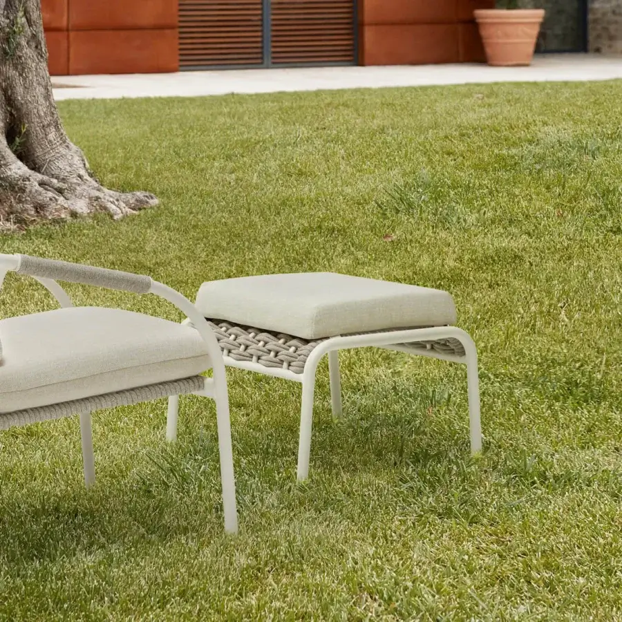 Handcrafted Roberti Rattan Capri pouf with light beige textile upholstery and powder-coated aluminum frame