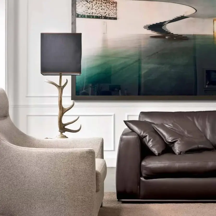Luxury CTS Salotti Andy sofa in dark brown leather with rounded arms and a sleek tubular aluminium base