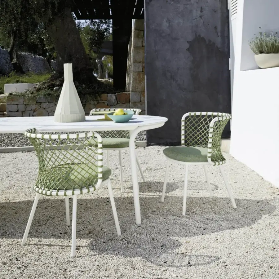 Distinguished Roberti Rattan Charme armchair crafted with muted green woven Flat Trendyrope and a matte white powder-coated steel frame