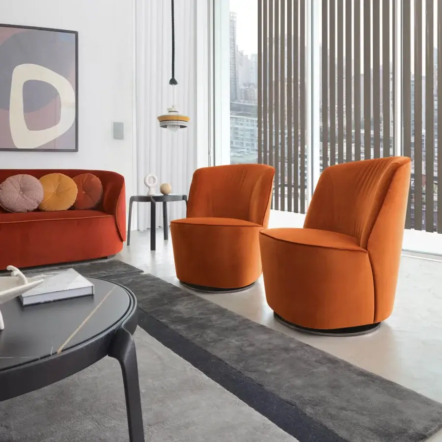 Sumptuous CTS Salotti Cocoon lounge chair fully upholstered in saturated orange velvet with sleek metal swivel base