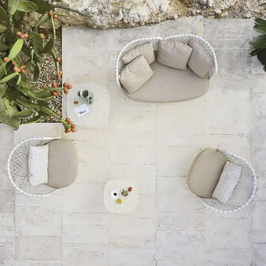 Distinguished Roberti Rattan Charme lounge chair crafted with powder-coated 304 steel and Flat Trendyrope in neutral beige with bright white exterior