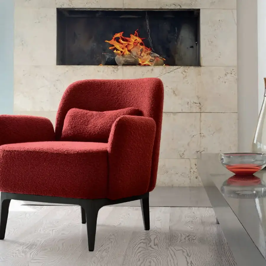 Superior CTS Salotti Margot lounge chair with reddish-orange bouclé-like textile upholstery and dark matte wooden base