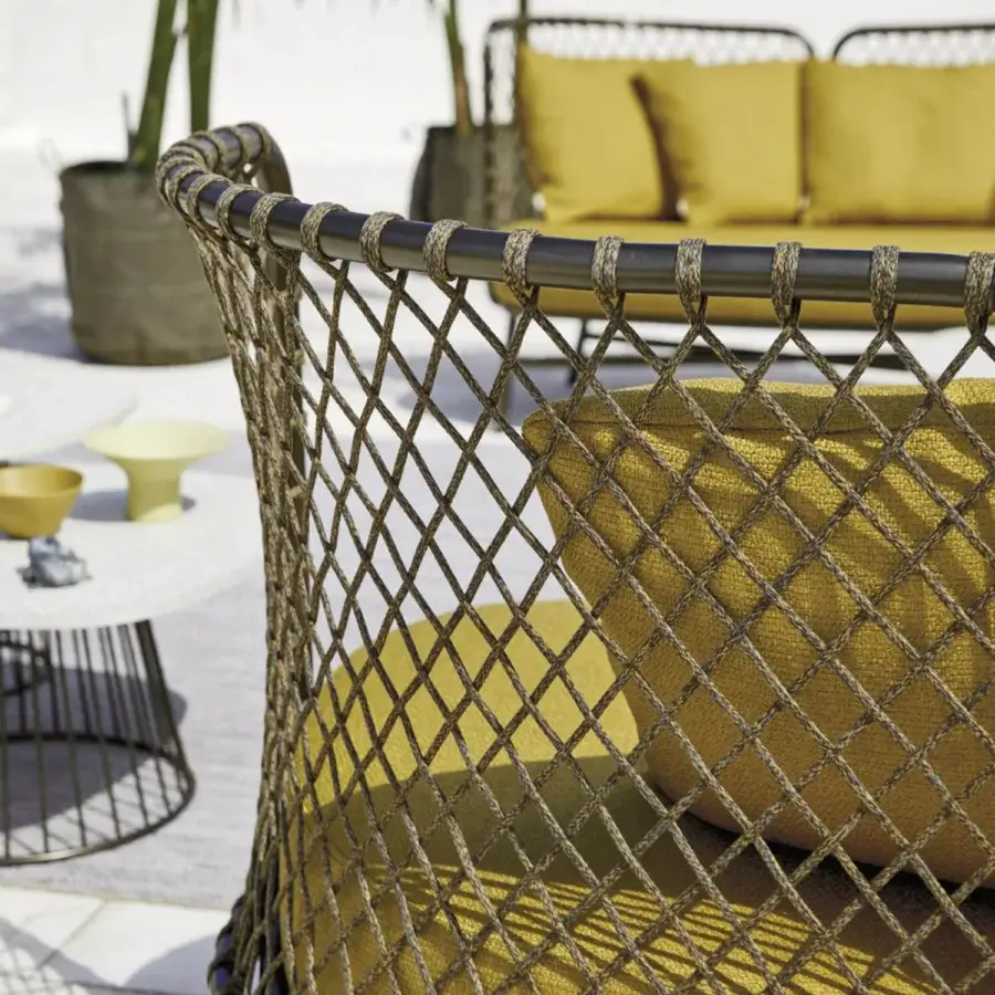 Distinguished Roberti Rattan Charme sofa crafted with golden-yellow Flat Trendyrope and powder-coated 304 steel, exhibiting a diamond weave