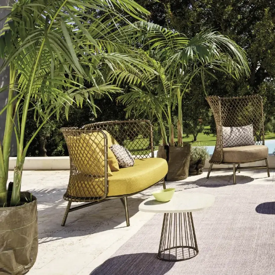 Exceptional Roberti Rattan Charme sofa with a curved profile, mustard yellow cushion and brown woven steel frame