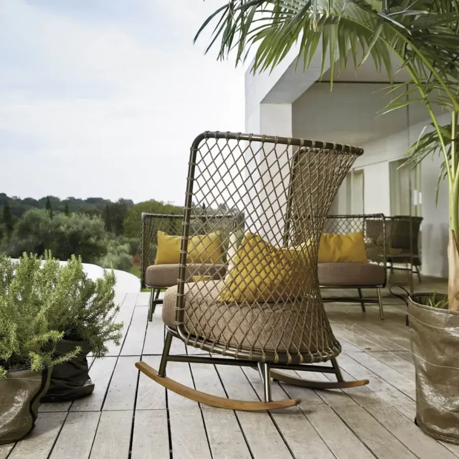 Superior Roberti Rattan Charme rocking lounge chair crafted with Flat Trendyrope, powder-coated steel, yellow cushions and light-toned wooden rockers
