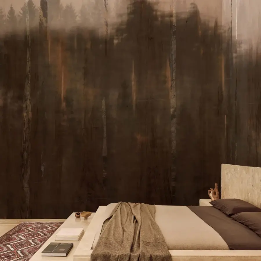 Elegant Wall&Decò Ghostforrest wallpaper with blurred tree forms in muted grays and dark browns on organic bio-vinyl with d.TW texture