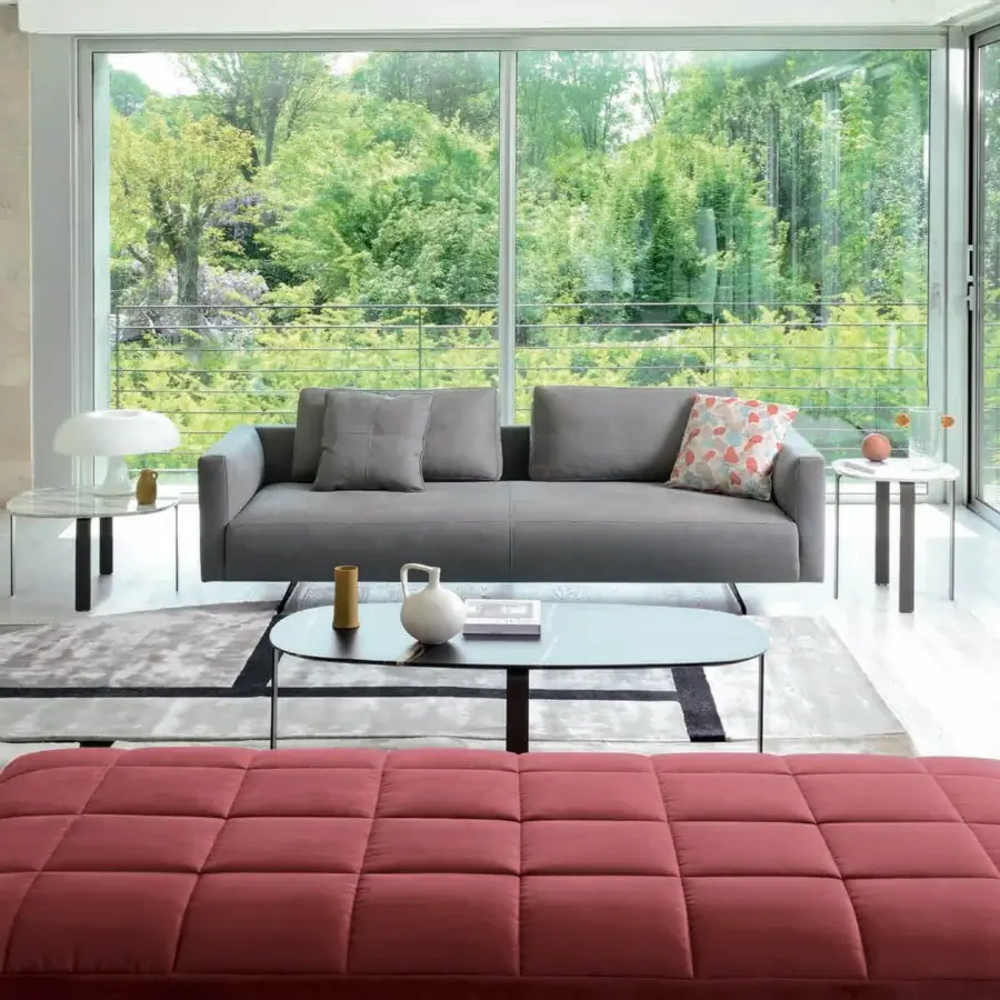 Exclusive CTS Salotti Ikon sofa with medium gray textile upholstery and patterned cushions in blue, orange, and white hues