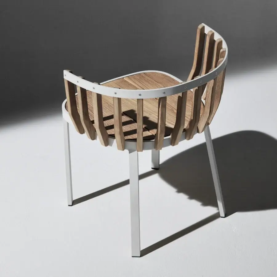 Distinguished Ethimo Swing armchair crafted with a matte white metal frame and satin finish teak slats