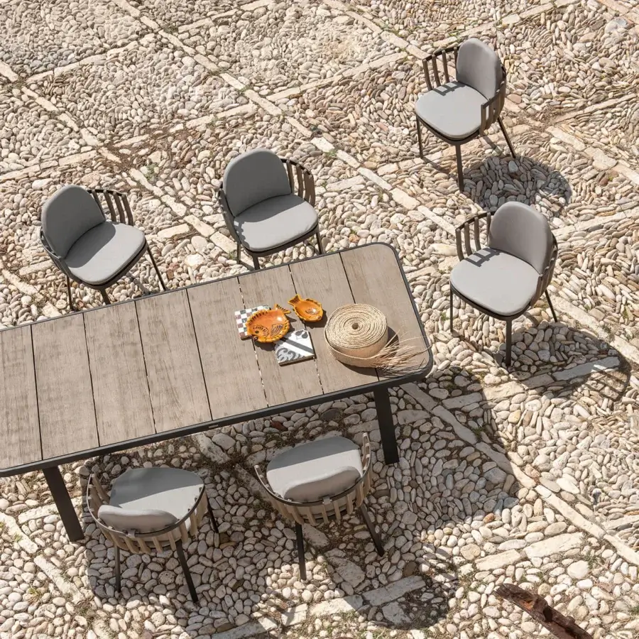Sophisticated Ethimo Swing armchair with dark-toned metal and teak slats, upholstered in light gray textured textile