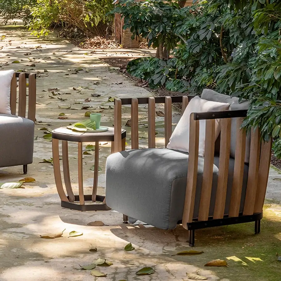 Distinguished Ethimo Swing side table with dark metal frame and precisely arranged teak slats in a satin finish
