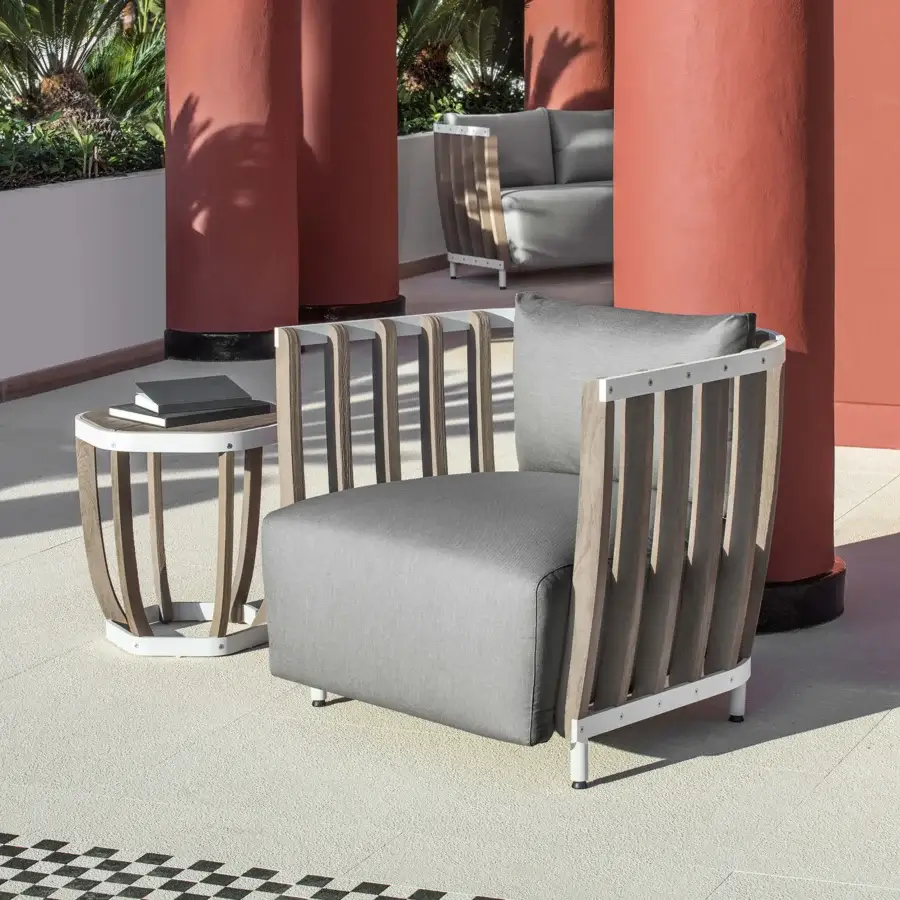 Distinguished Ethimo Swing side table with silver metal frame and teak slats in a muted gray-brown tone with matte finish