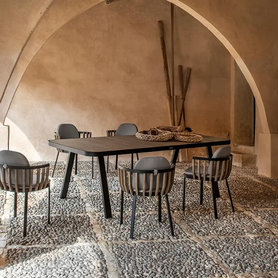 Sophisticated Ethimo Swing table with a dark gray aluminum structure and a teak slat tabletop in a matte finish