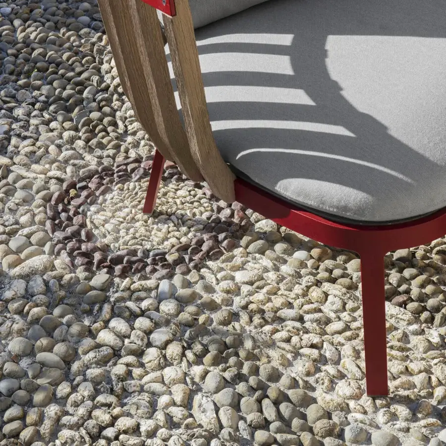 Distinguished Ethimo Swing lounge chair with matte red metal, teak slats and light gray cushioning crafted for indoor or outdoor use