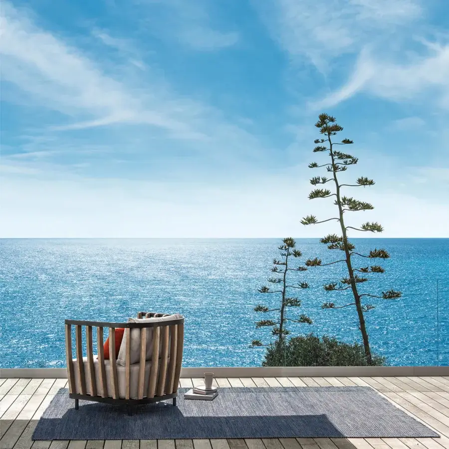 Superior Ethimo Swing lounge chair with a metal frame, warm teak slats and vibrant orange cushions woven in neutral gray