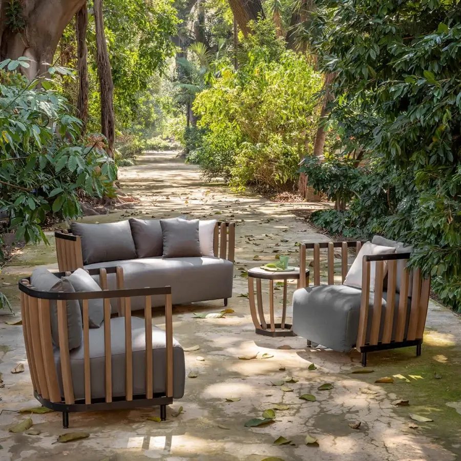 Distinguished Ethimo Swing lounge chair with sleek metal, warm teak slats and smooth light gray textile upholstery