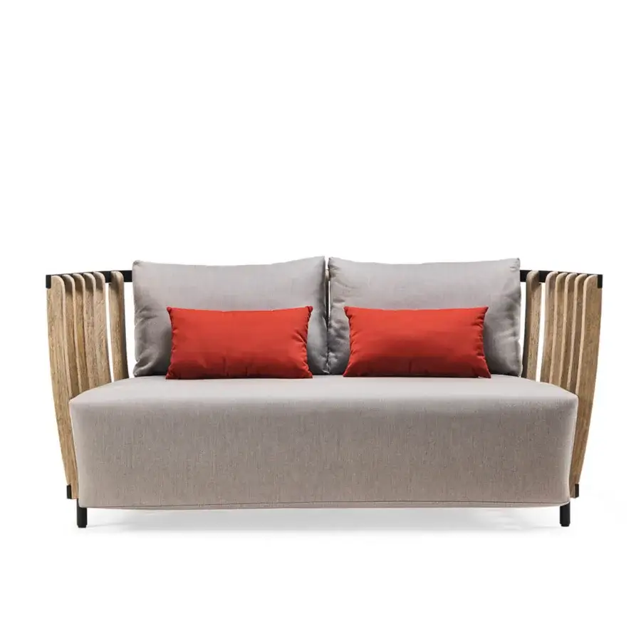Refined Ethimo Swing sofa built with dark metal, light teak slats, textured neutral gray textile, and reddish-orange accent cushions