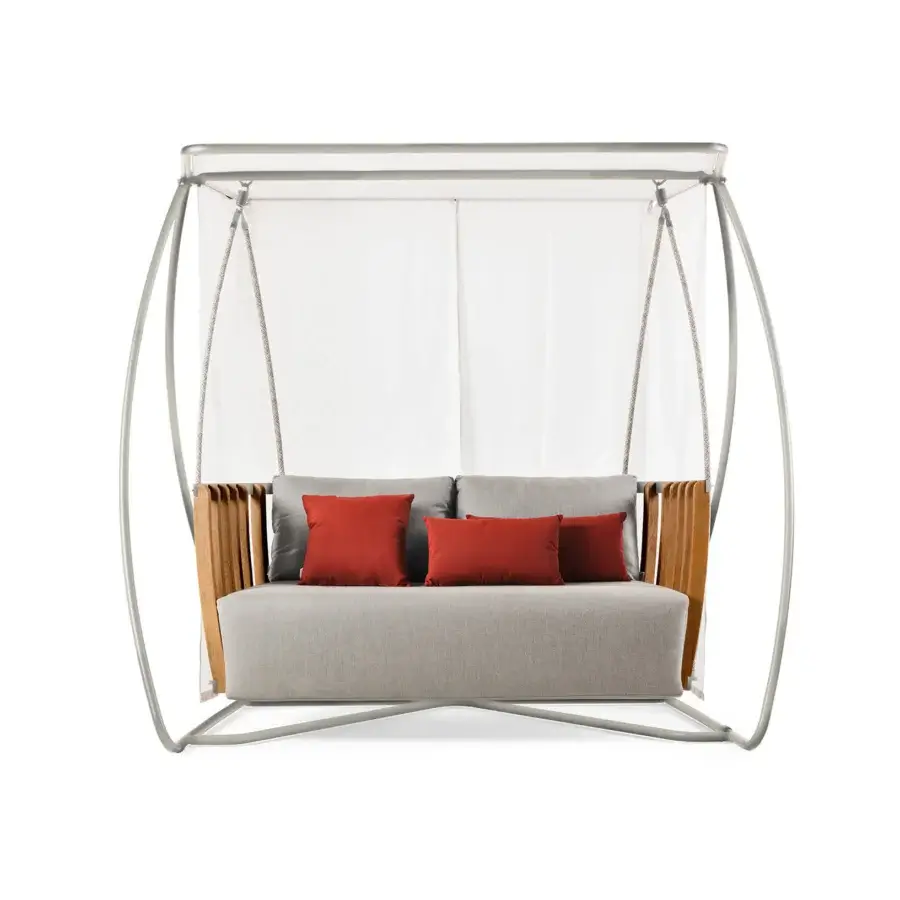 Superior Ethimo Swing hanging sofa with a slender metal frame and rhythmic teak slats supporting a light gray cushion with reddish-orange pillows