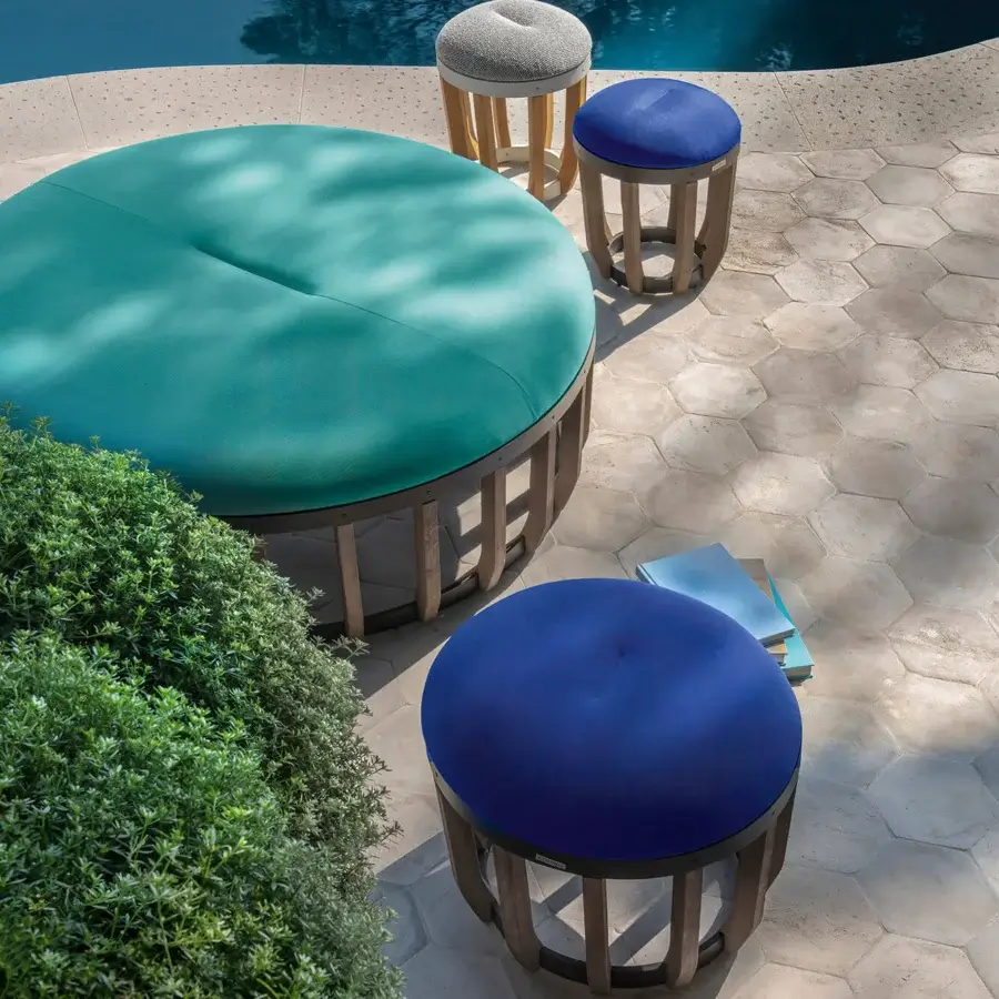 Superior Ethimo Swing ottoman with vibrant teal textile upholstery and meticulously crafted teak-slatted base