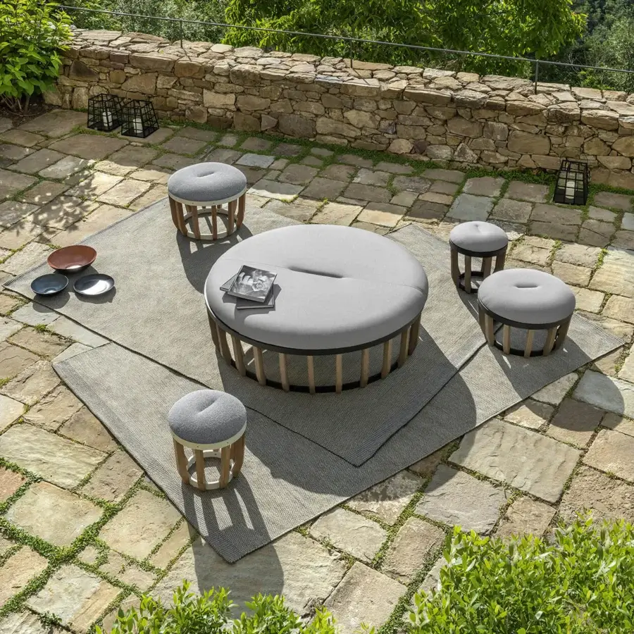 Captivating Ethimo Swing ottoman with light gray plush cushioning and robust teak-slatted base crafted in Italy