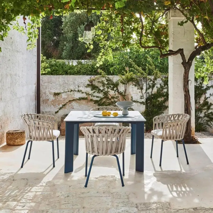 Captivating Varaschin Emma Cross armchair with woven light fiber rope, dark blue aluminum frame and neutral seat cushion