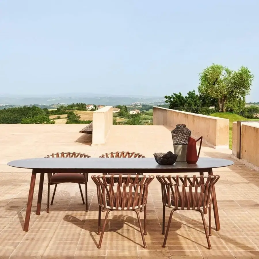 Distinguished Varaschin Emma Cross armchair with warm brown powder-coated aluminum and woven synthetic fiber rope with acrylic fabric