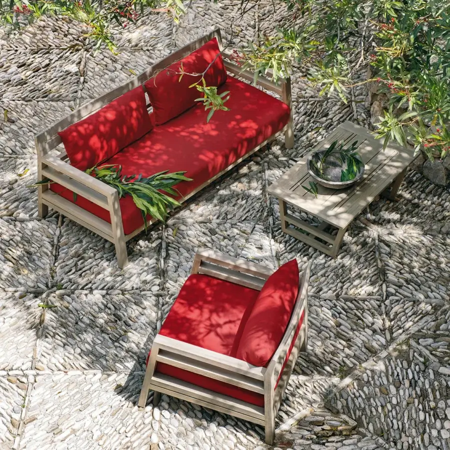 Exceptional Ethimo Costes sofa crafted with FSC-certified teak in a natural finish with vibrant red cushions