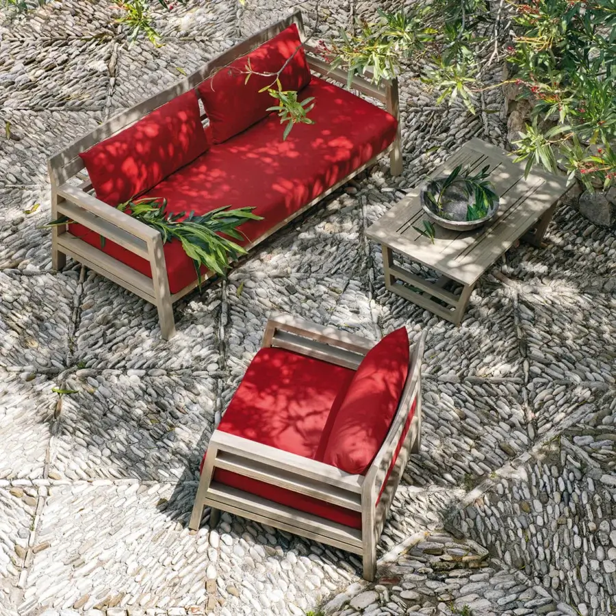 Refined Ethimo Costes lounge chair crafted with FSC-certified teak and a striking red cushion in a pickled finish