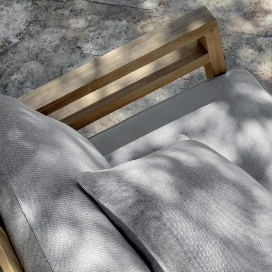 Sophisticated Ethimo Costes lounge chair crafted with FSC-certified teak and light gray cushions with a pickled finish