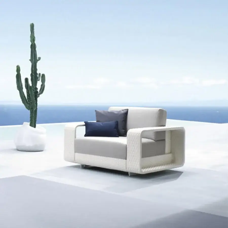 Exceptional Roberti Rattan Hamptons lounge chair crafted with aluminum and textured Sunweave, in neutral beige with dark blue support