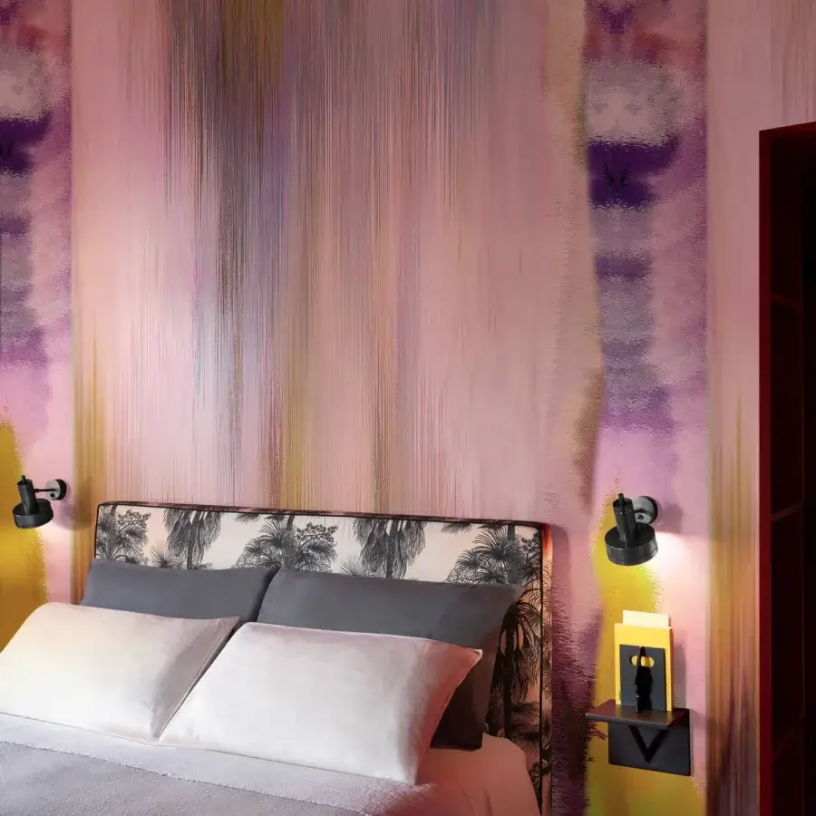 Superior Wall&Decò Cascata wallpaper showcases abstract vertical lines in pale pink, lavender, and purple tones with a delicate fabric-effect surface