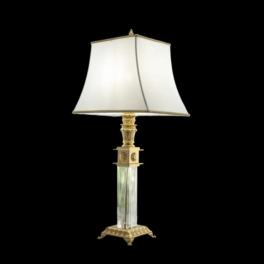 Distinguished Laudarte Andromeda table lamp crafted in bronze with 24K gold plating and clear crystal column with a light cream textile shade