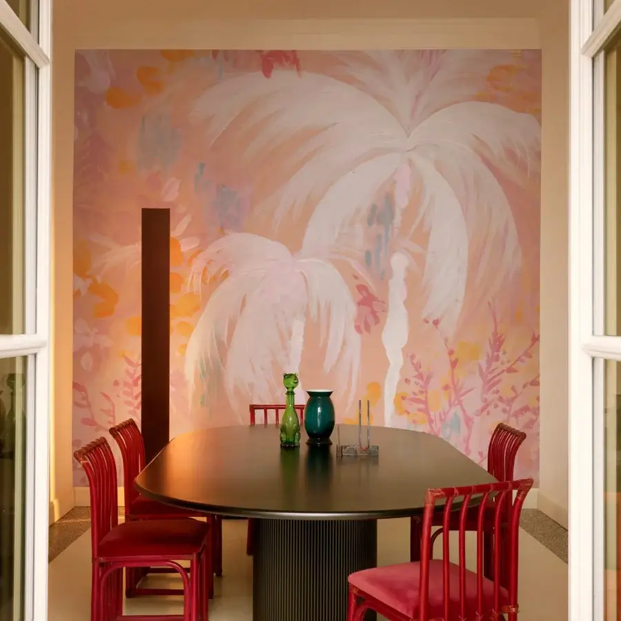 Superior Wall&Decò Paloma wallpaper with stylized palm fronds and painterly texture in soft pink and peach hues on d.ecodura™ Sand finish