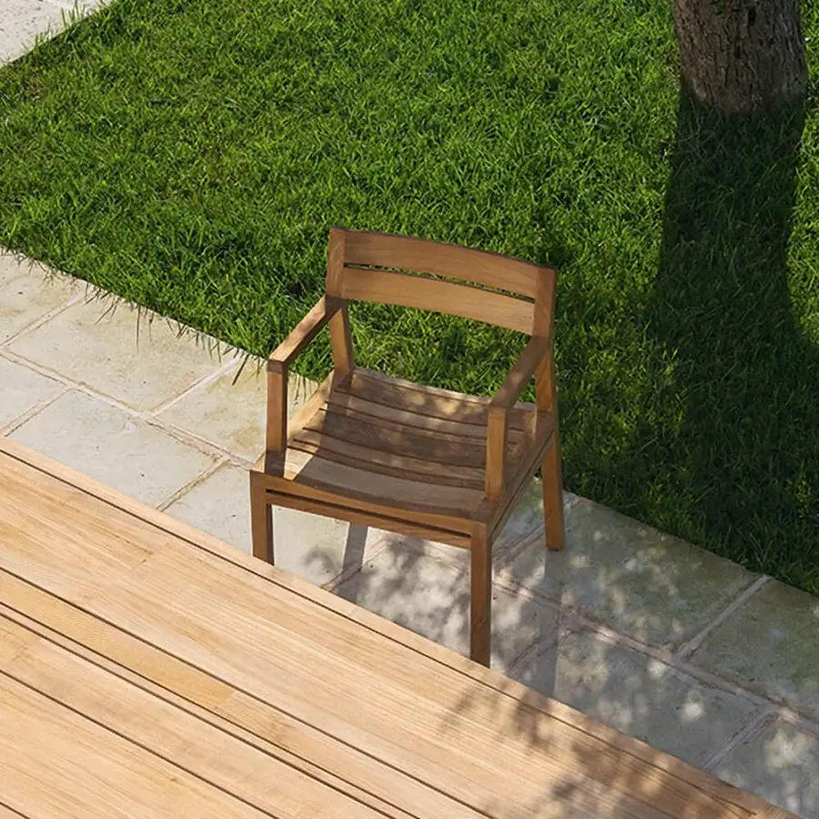 Captivating Ethimo Costes armchair crafted with FSC-certified teak and a warm natural finish for balanced outdoor seating