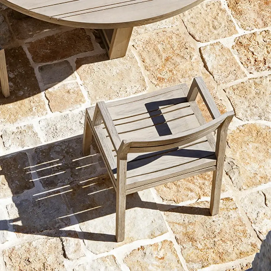Distinguished Ethimo Costes armchair with FSC-certified teak structure and dark grey textile back in a pickled finish