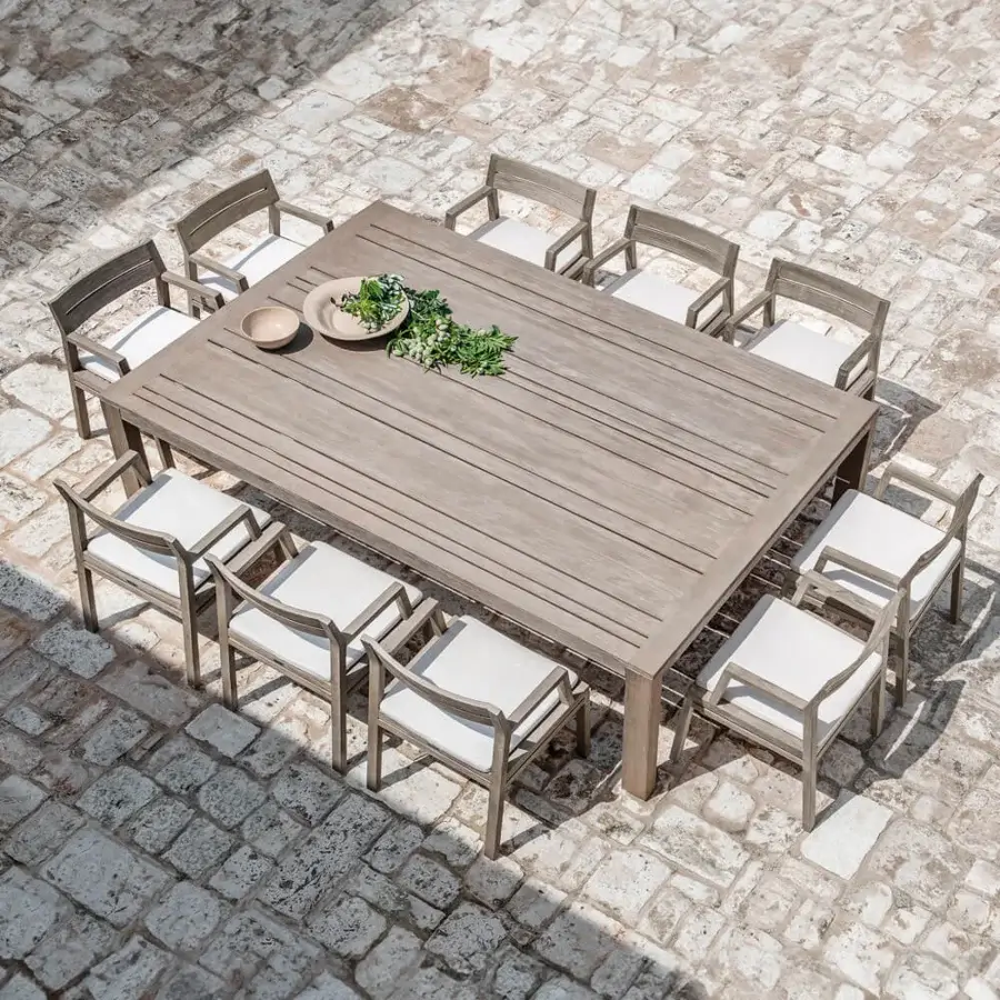 Captivating Ethimo Costes armchair crafted with FSC-certified teak and inviting off-white textile cushions in a natural finish
