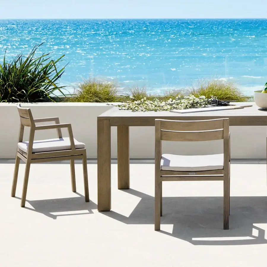 Distinguished Ethimo Costes armchair with FSC-certified teak structure and a warm natural finish in a muted gray-brown tone