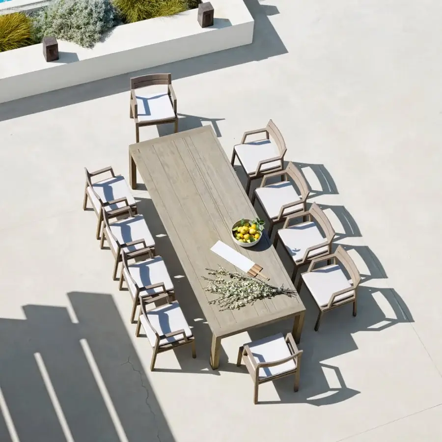 Elegant Ethimo Costes armchair with FSC-certified teak frame and inviting neutral white upholstery in a warm natural finish