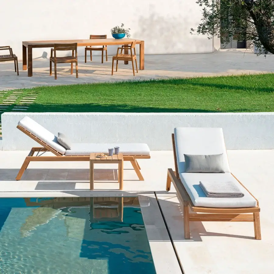 Exceptional Ethimo Costes lounger with warm teak frame and comfortable off-white cushions in a satin finish