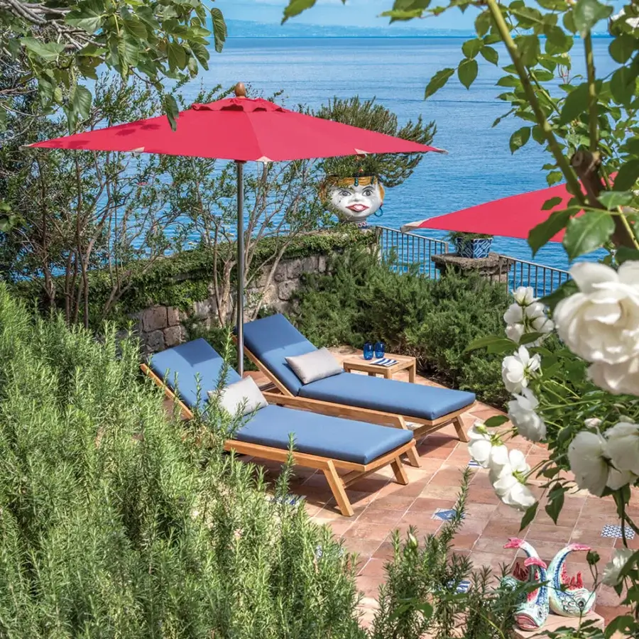 Sophisticated Ethimo Costes lounger crafted in FSC-certified teak with muted blue-grey tones and subtle beige stitching
