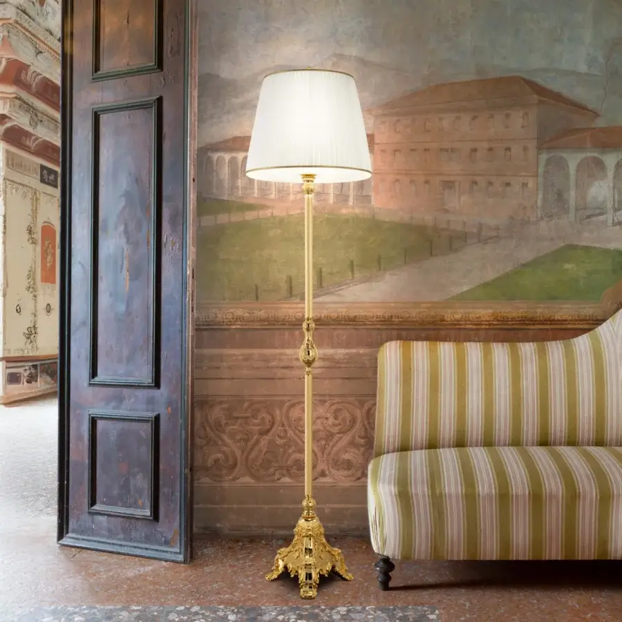 Superior Laudarte Gemma floor lamp crafted in bronze with 24K gold plating and a cream lampshade with gold trim